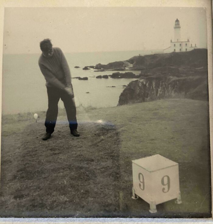 Vintage black and white photo of a man playing golf near a cliffside lighthouse in a where was this taken post.
