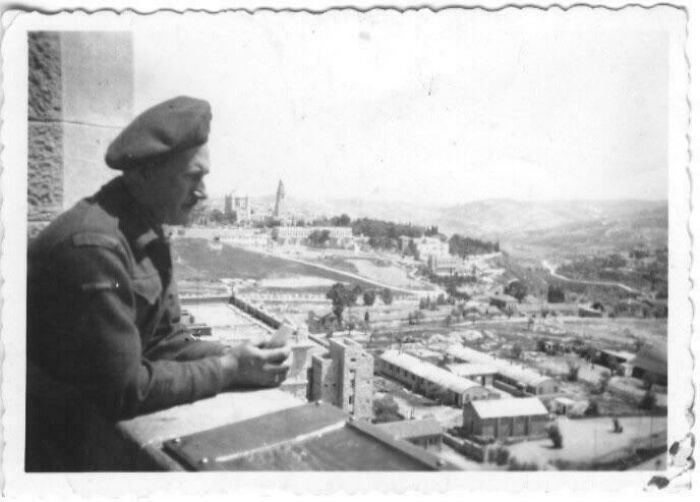 Black and white photo of a soldier overlooking a cityscape, illustrating popular where was this taken posts online.