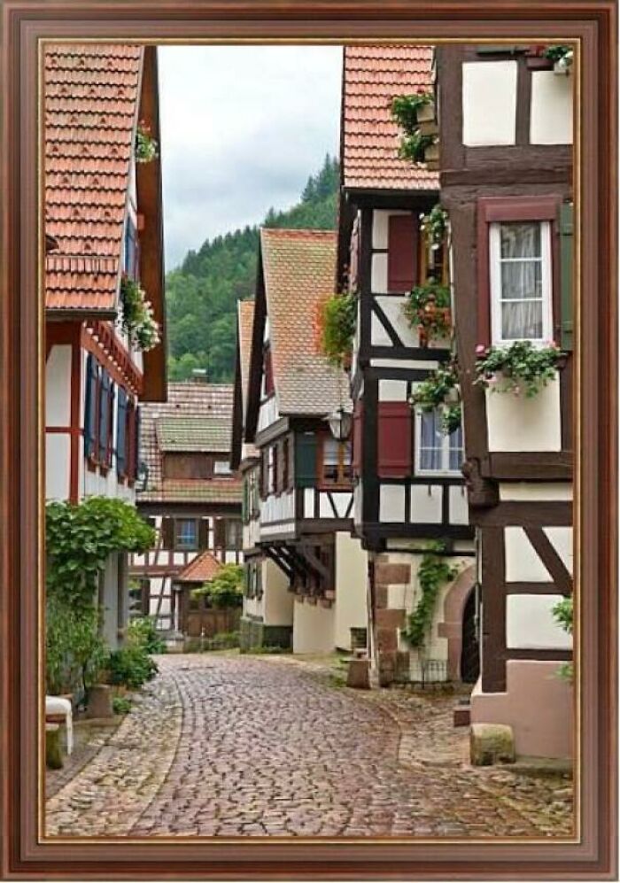 Charming cobblestone street with traditional half-timbered houses in a picturesque European village scene where was this taken posts.
