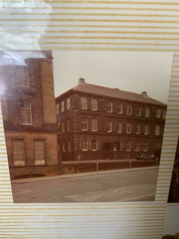 Vintage photo of a brick building along a street, part of where was this taken internet posts collection.