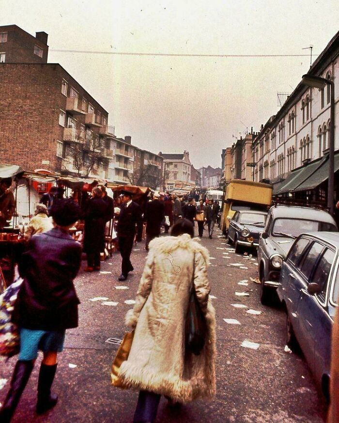 Vintage street market scene with people and parked cars, illustrating where was this taken posts trending on the internet.