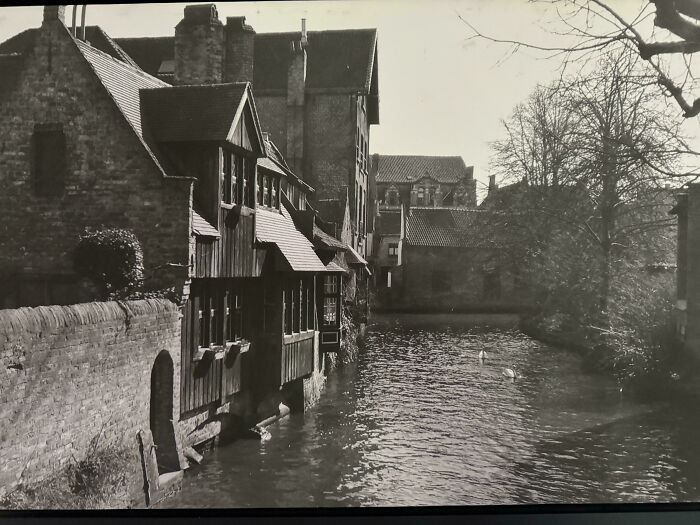 Black and white photo of old riverside buildings and waterway in a vintage scene for where was this taken posts online.