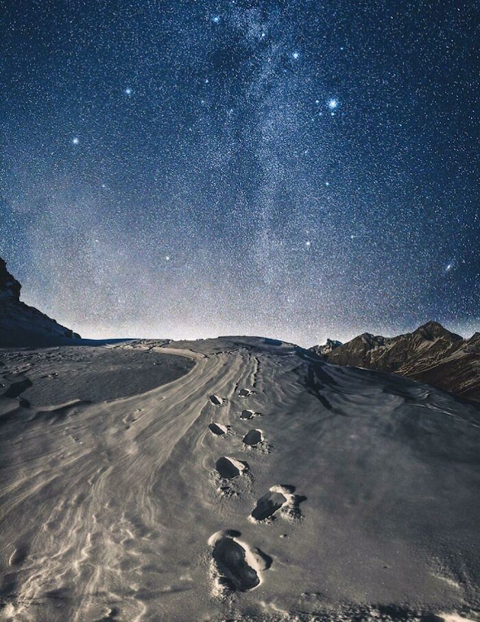 Footprints in snow under a starry night sky, symbolizing dreams turned into reality and inspiring the internet.