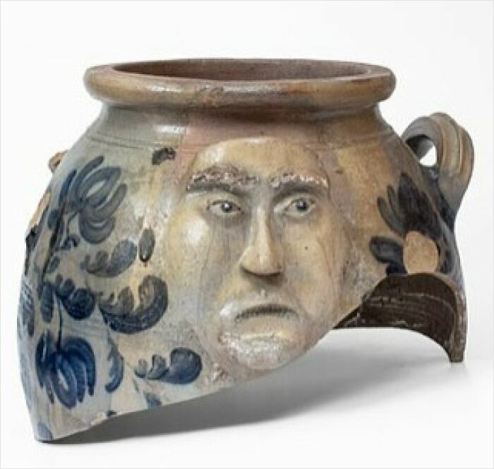 Ancient pottery fragment with a human face design, showing very old objects that survived from our ancestors.