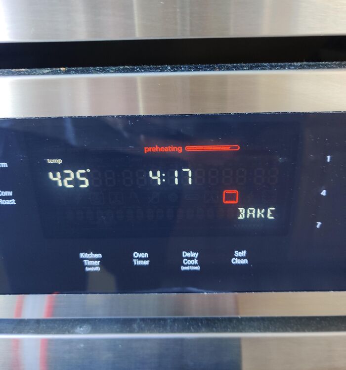 Oven digital display preheating to 425 degrees with timer set, showcasing smart inventions that solve cooking problems.