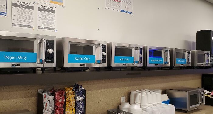 Row of microwaves labeled for different dietary needs such as vegan, kosher, halal, vegetarian, showcasing smart ideas and inventions.