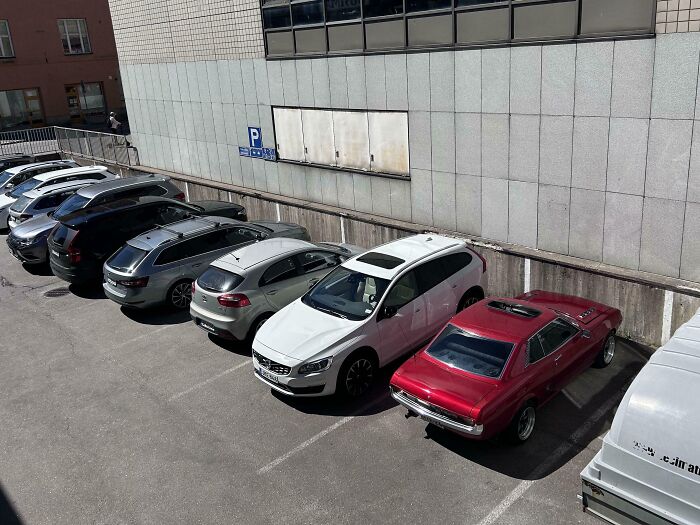 A row of parked cars in an outdoor lot showcasing smart inventions solving everyday parking problems.