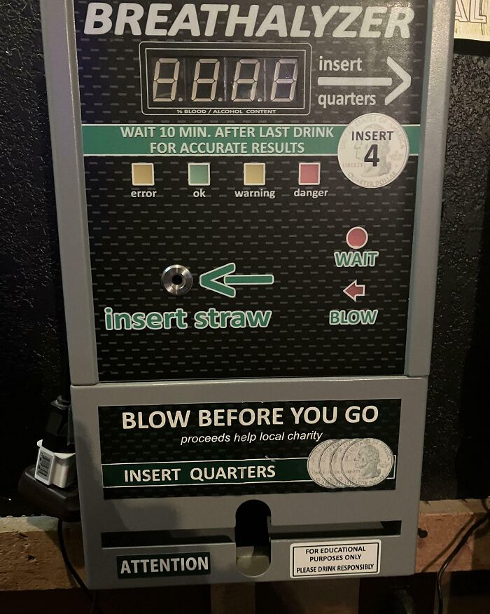 Breathalyzer device showing instructions to insert quarters and straw for an accurate alcohol level reading.
