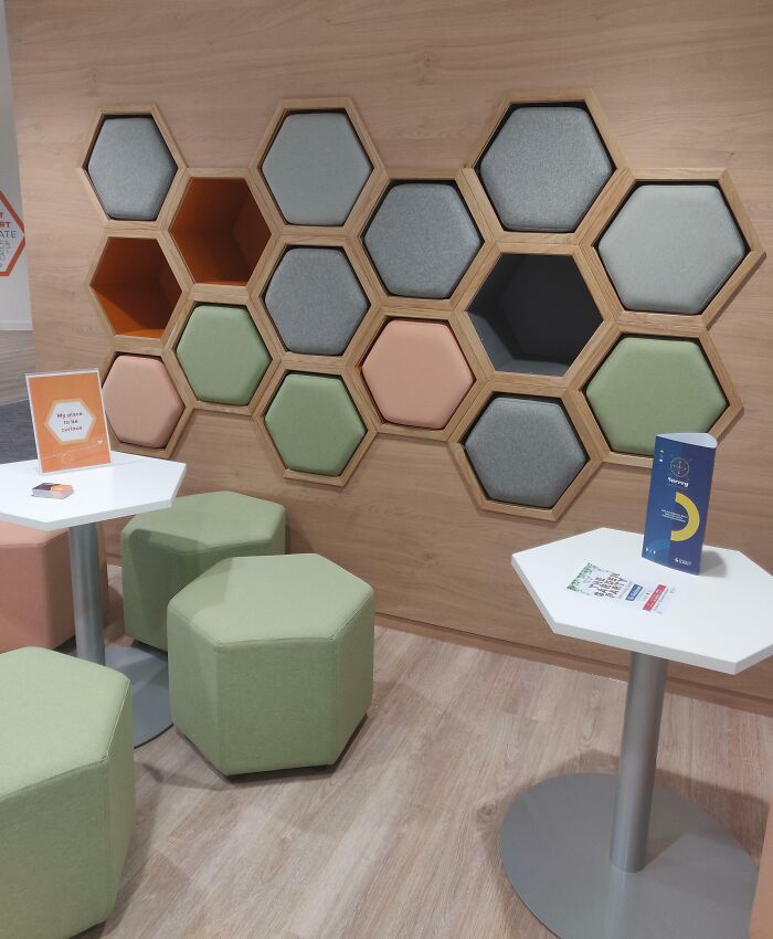 Modern seating area with hexagonal cushions and tables showcasing smart ideas and inventions solving space problems.