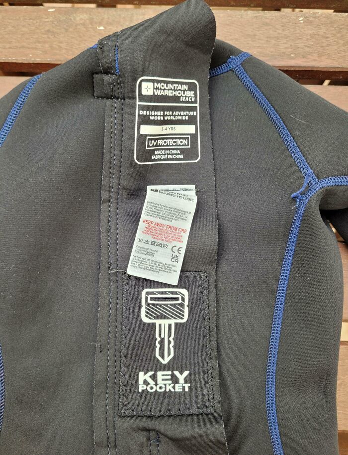 Close-up of a wetsuit featuring a built-in key pocket, showcasing smart ideas and inventions solving everyday problems.
