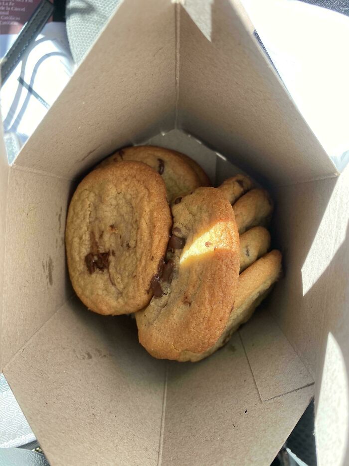 Chocolate chip cookies inside a cardboard box, illustrating a lighthearted take on juicy steak and buttery lobster complaints.