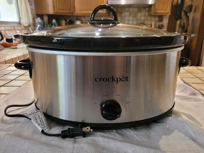 Stainless steel Crockpot slow cooker on kitchen counter, a popular Black Friday deals wishlist item.