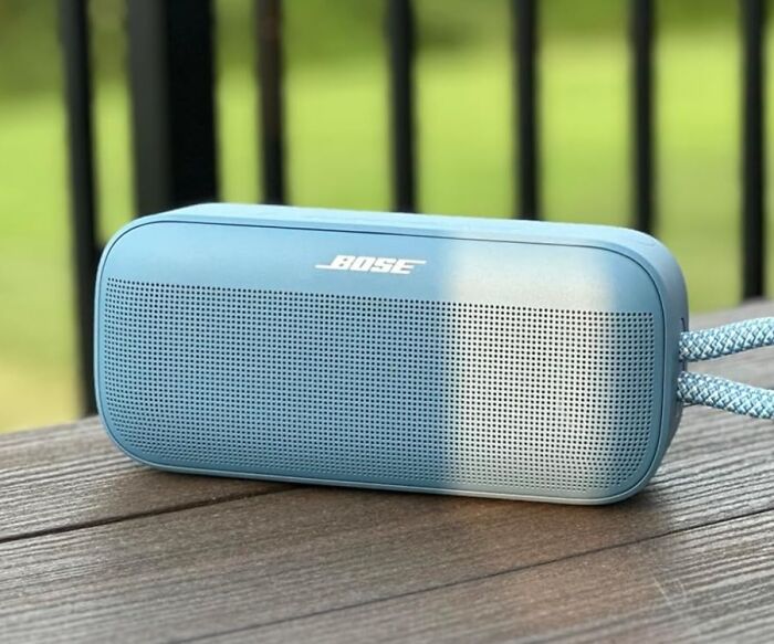 Portable blue Bose speaker on wooden surface, featured in Black Friday deals to add to your wishlist.