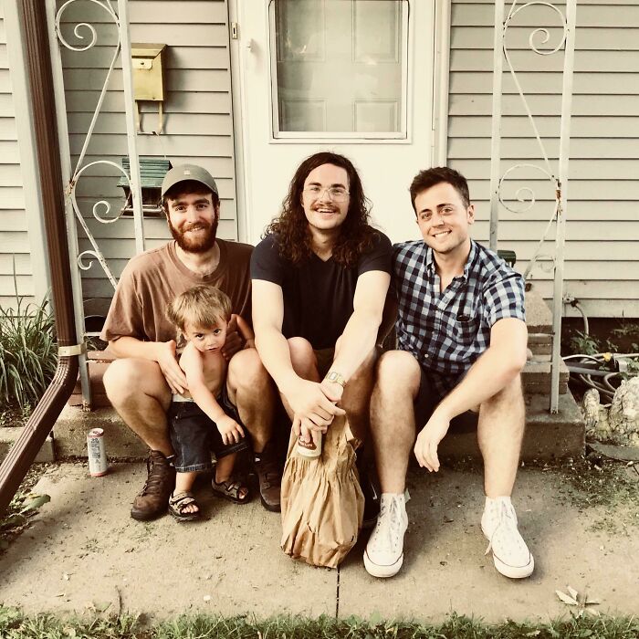 Three men and a child smiling outside a house, capturing moments of people turning dreams into reality and inspiring others.