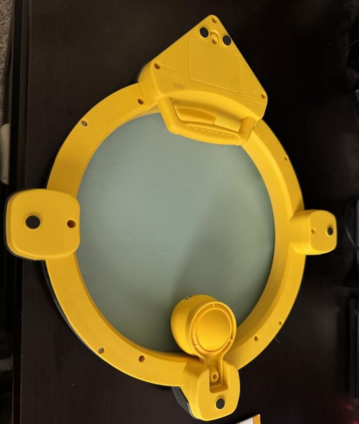 Yellow circular device with handle and attachments, a unique stocking stuffer gift idea for holiday presents.