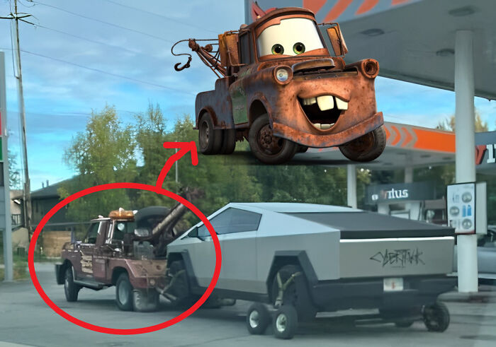 Rusty tow truck at a gas station that looks like the animated character Mater, reminding people of cars.