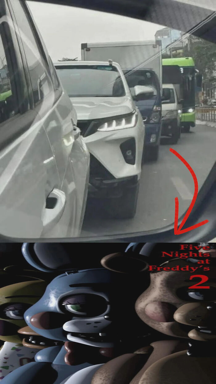 Side mirror reflection of a car headlight resembling animatronic characters from popular video game horror series.