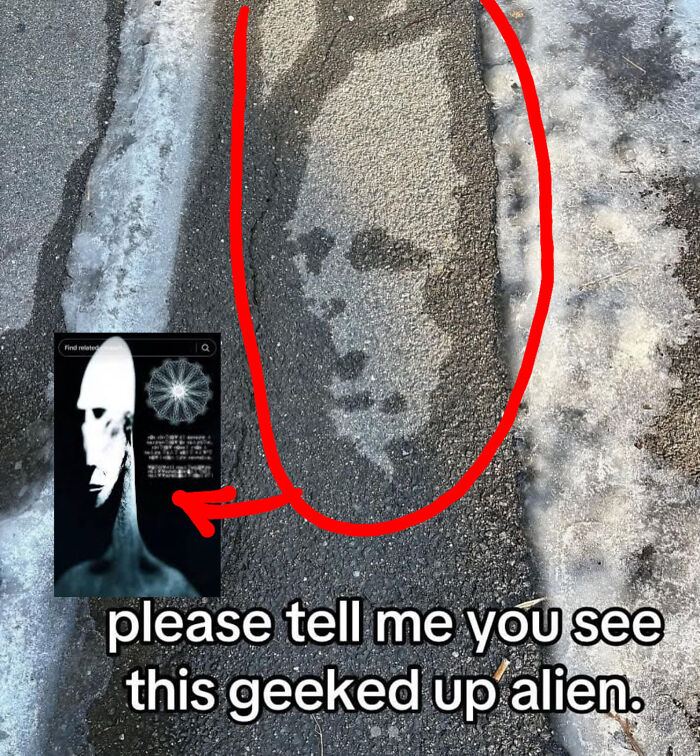 Alien face shape on pavement surrounded by snow resembling a geeked up figure, one of the things that look like other things.
