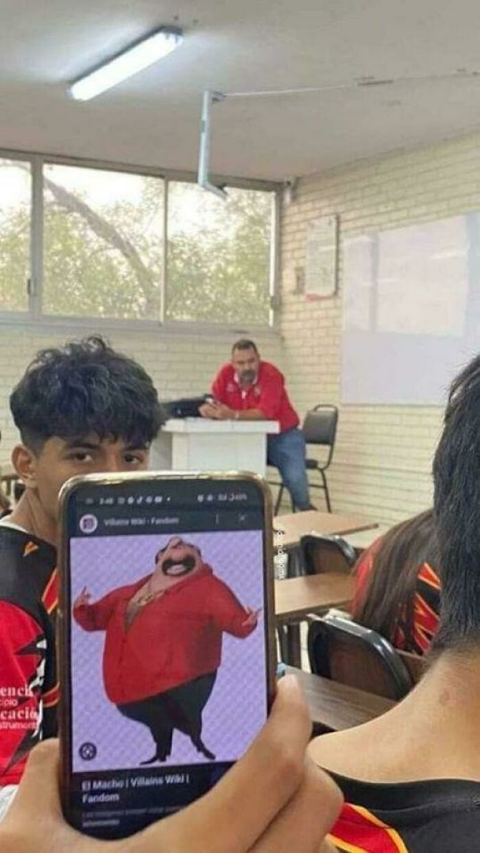 Classroom scene showing a man in a red shirt resembling a cartoon character on a phone, highlighting things that look like other things.