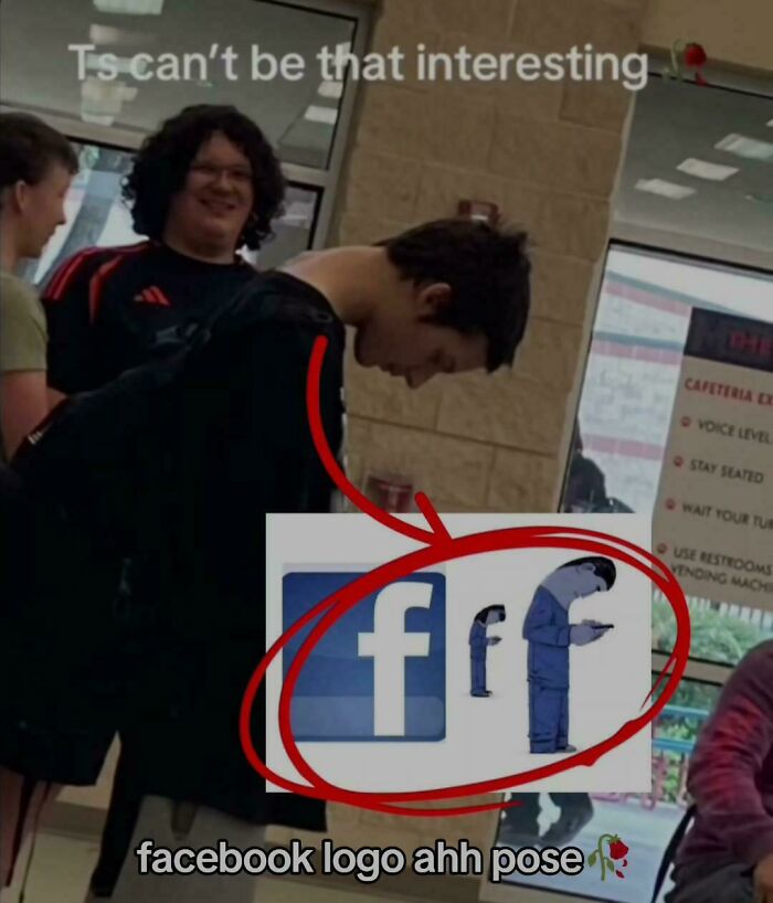 Two people standing inside a building, one person leaning forward resembling a pose from things that look like other things.