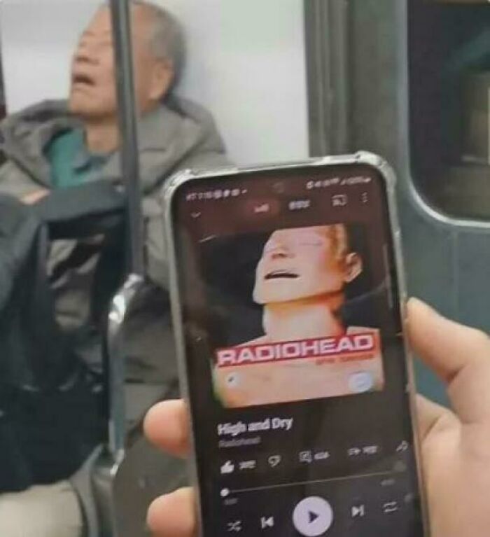 Man on subway looks like Radiohead album cover on phone, illustrating things that remind people of other things.