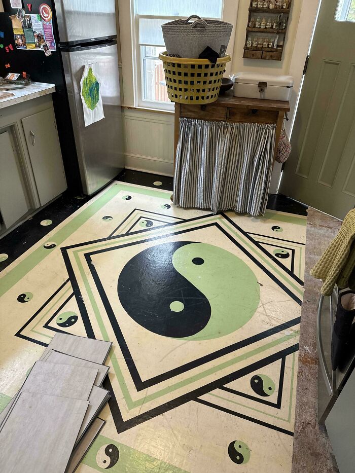 Vintage kitchen floor with yin-yang design showcasing craftsmanship in a beautiful old house interior.