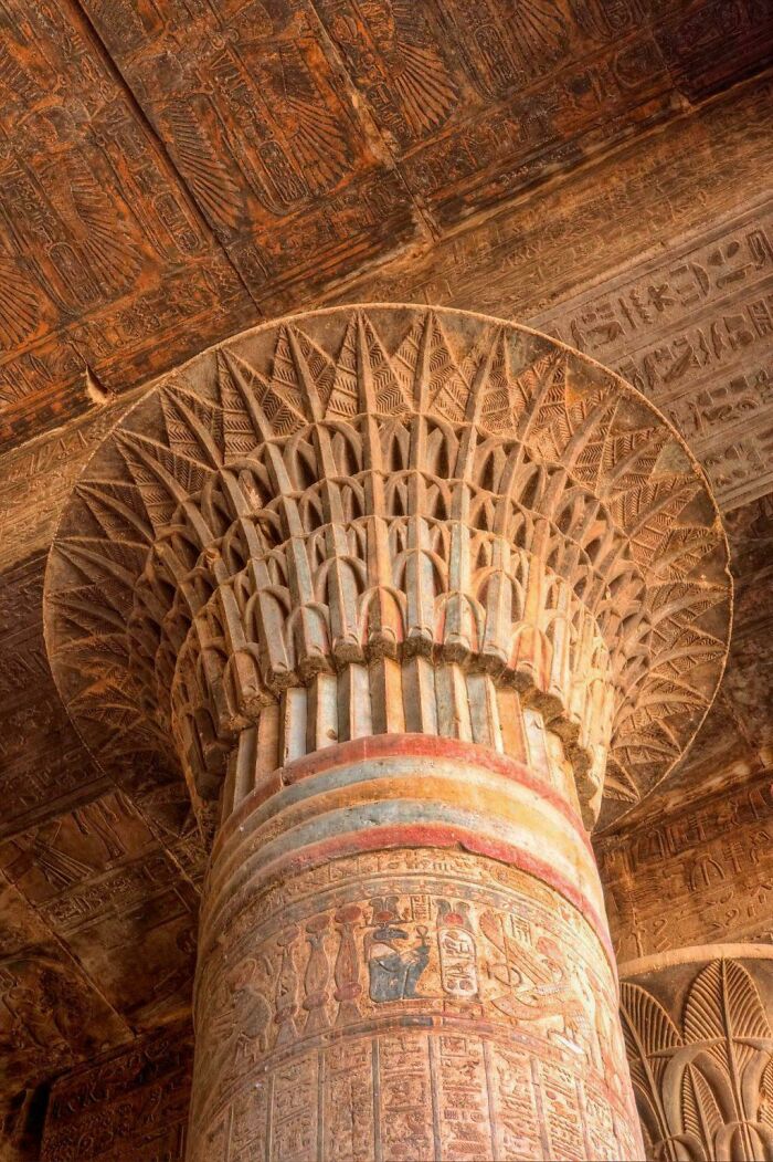 Ancient Egyptian column with detailed carvings and hieroglyphs, showcasing fascinating archeology finds from around the world