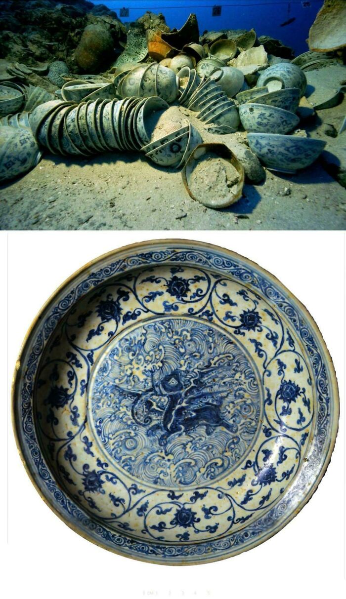 Underwater archeology site showing ancient blue and white pottery shards and a detailed decorative ceramic plate.