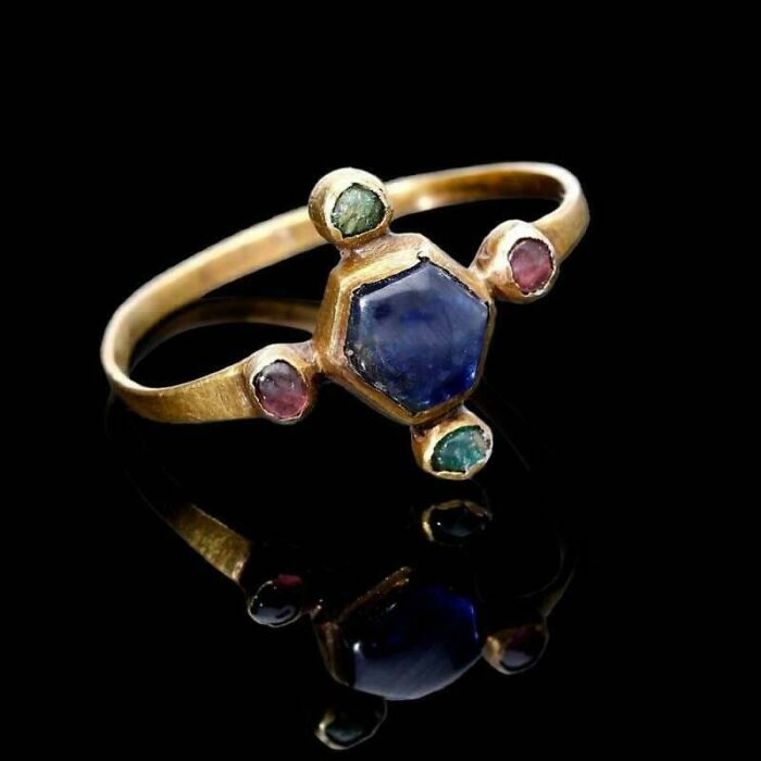 Ancient gold ring with blue and green gemstones, one of the fascinating archaeology finds from around the world.
