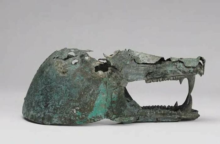 Ancient bronze animal head artifact, a fascinating archeology find from around the world with weathered and corroded details.