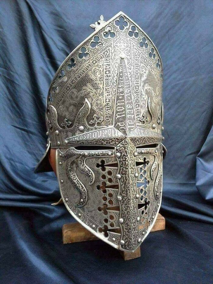 Ornate medieval helmet with intricate designs, an impressive archeology find showcasing historical metalwork craftsmanship.