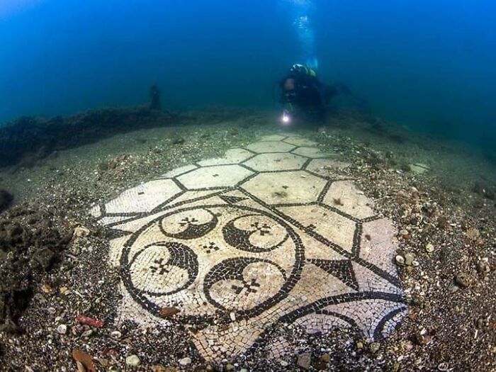 Underwater archaeologist exploring an ancient mosaic floor, one of the fascinating finds from around the world.