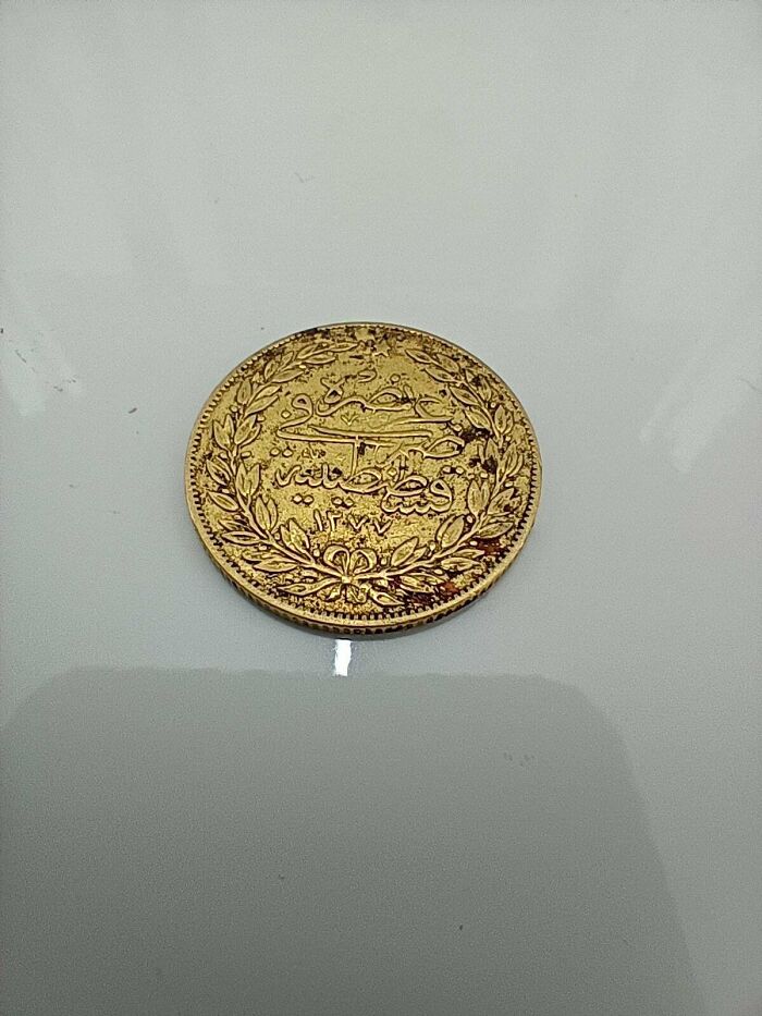 Ancient gold coin with intricate designs and inscriptions, a fascinating archeology find from around the world.