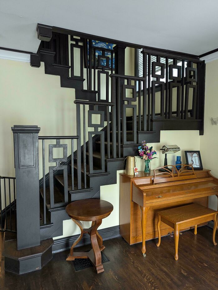 Intricately crafted wooden staircase and vintage piano showcasing beautiful old houses craftsmanship and timeless design.