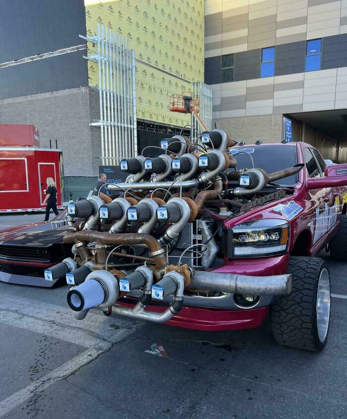 Custom car with overly complex intake pipes and filters, showcasing extreme and impractical car modifications gone wrong.