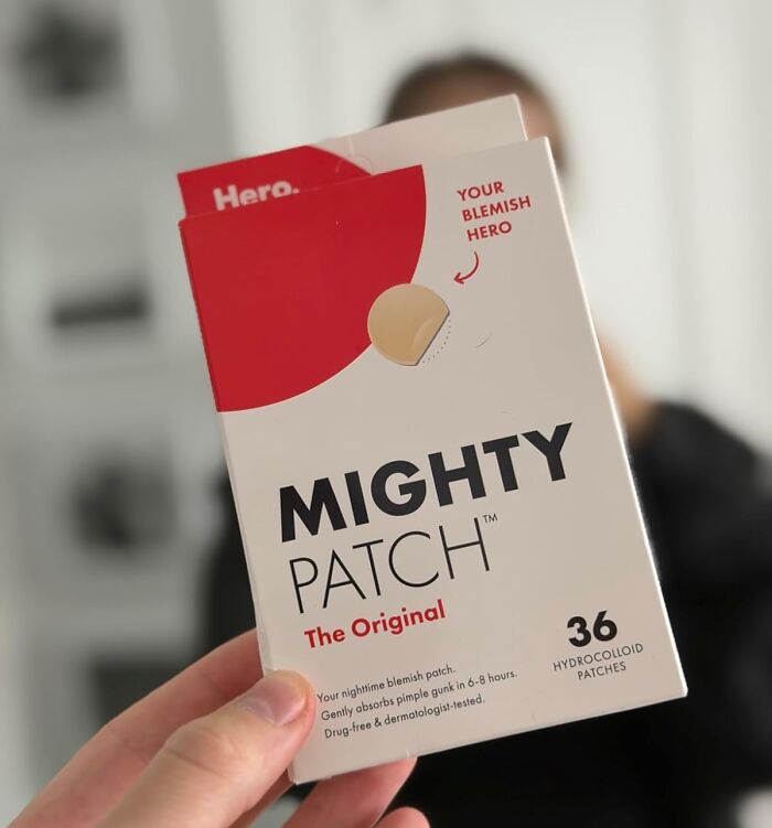 Hand holding Mighty Patch original blemish hydrocolloid patches, a top beauty deal for Black Friday restocking.