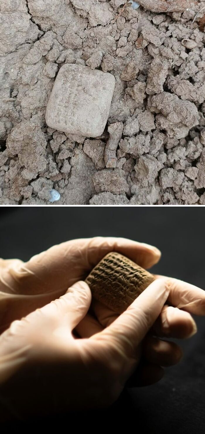 Ancient archeology finds including cuneiform tablets partially buried in soil and examined by gloved hands.