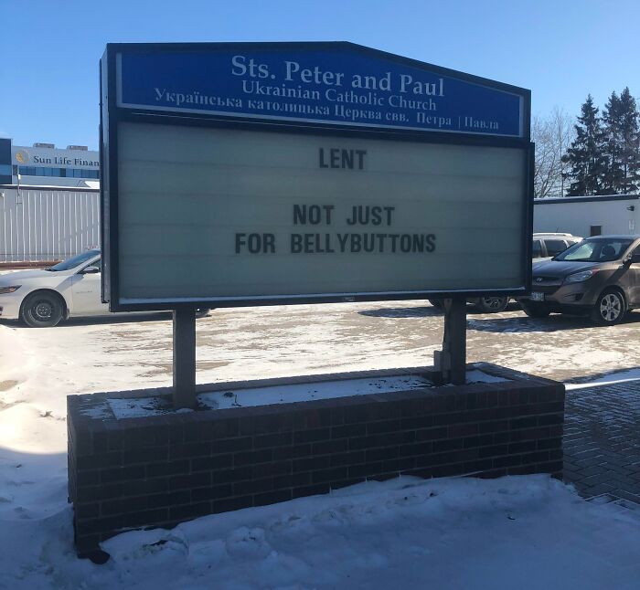 Church sign joke at Sts. Peter and Paul Ukrainian Catholic Church reading Lent not just for bellybuttons in winter parking lot.
