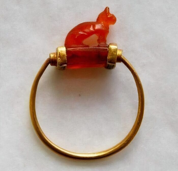 Ancient gold ring with a carved red stone in the shape of a cat, one of the fascinating archeology finds from around the world.