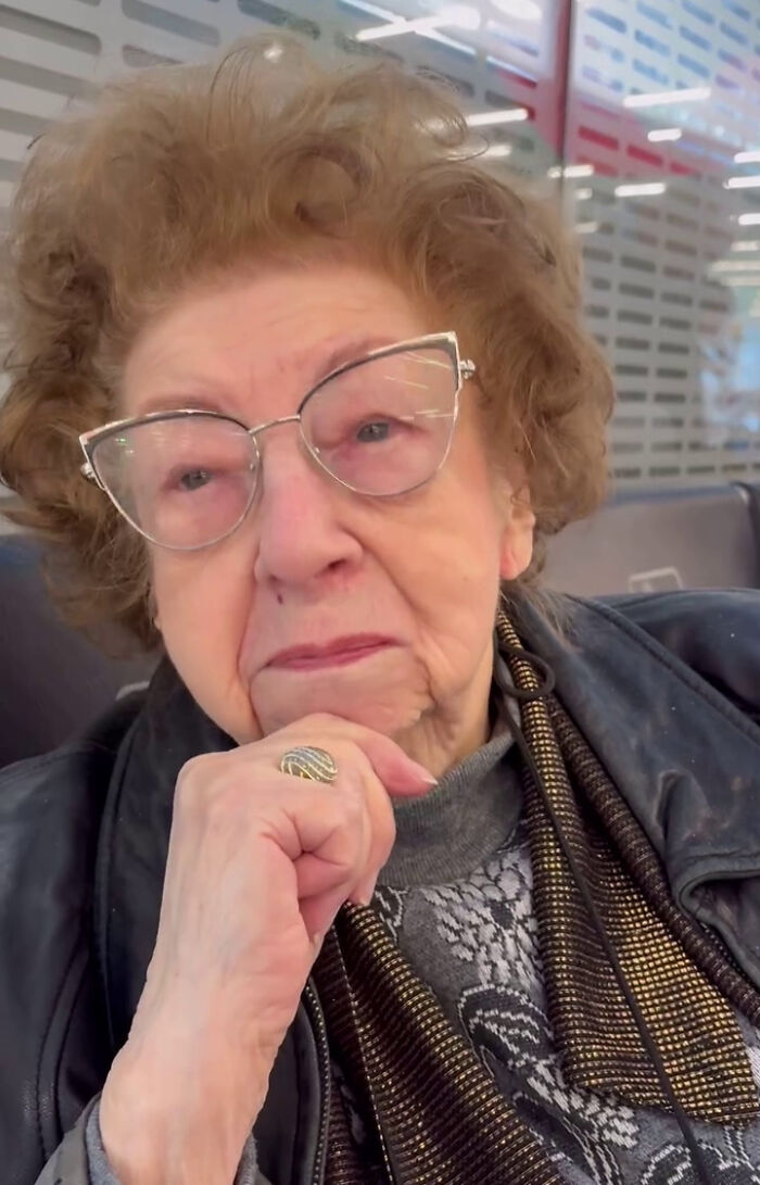 Elderly woman with glasses and curly hair posing thoughtfully, representing viral moments and internet icons.