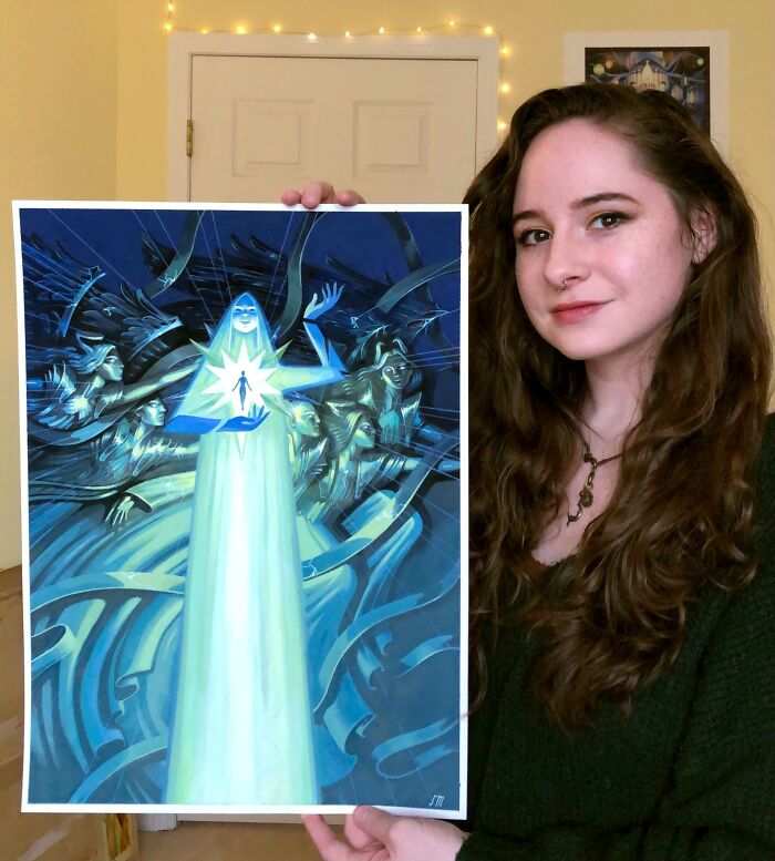 Young woman holding artwork depicting a glowing figure, representing people turning their dreams into reality and inspiring others online.