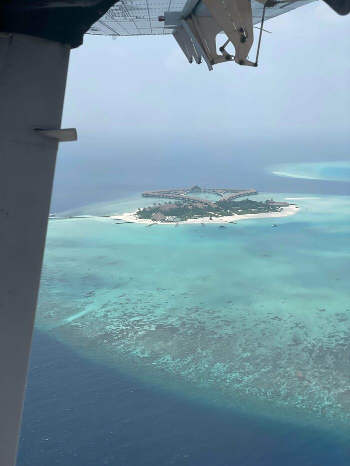 Aerial view of a tropical island with turquoise waters and white sandy beaches near Miami coastline.