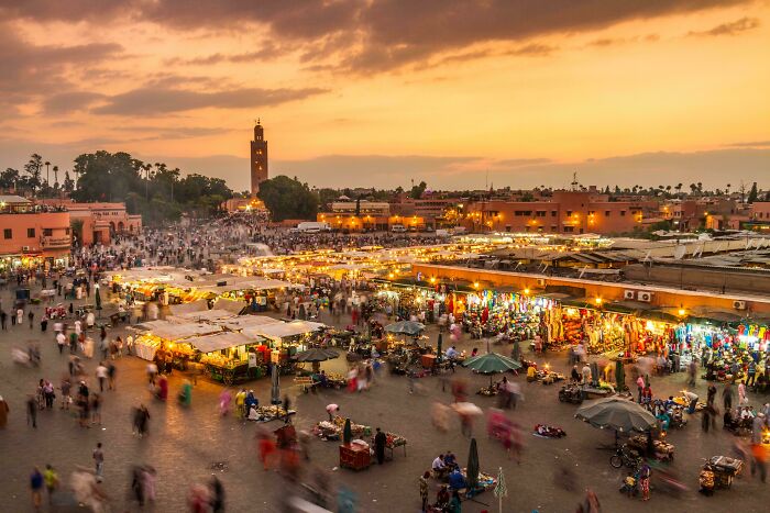 Busy outdoor market at sunset with colorful stalls and crowds, related to Miami city experiences and travel.