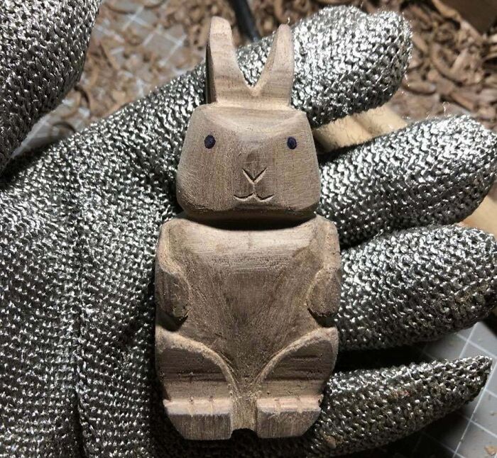 Hand-carved wooden rabbit figure held in a gloved hand, showcasing sibling gratitude through a thoughtful handmade gift.