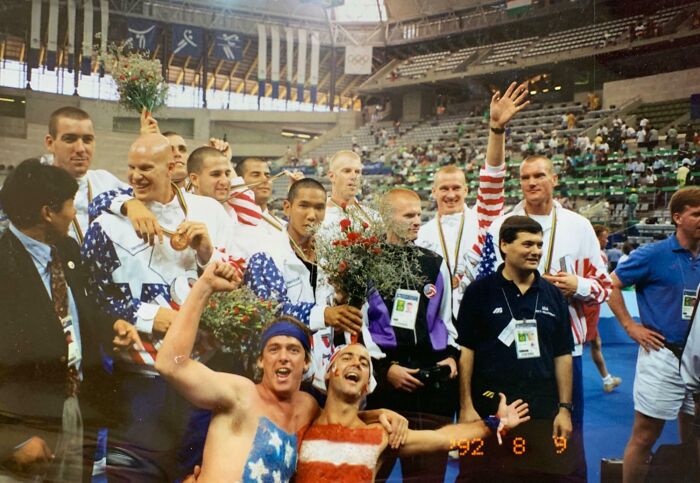 Group of athletes celebrating with flowers and medals showing epic photobombs that stole the show and made everyone laugh