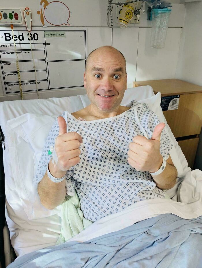 Man in hospital bed smiling and giving thumbs up, showcasing wholesome internet moments that inspire positivity online.