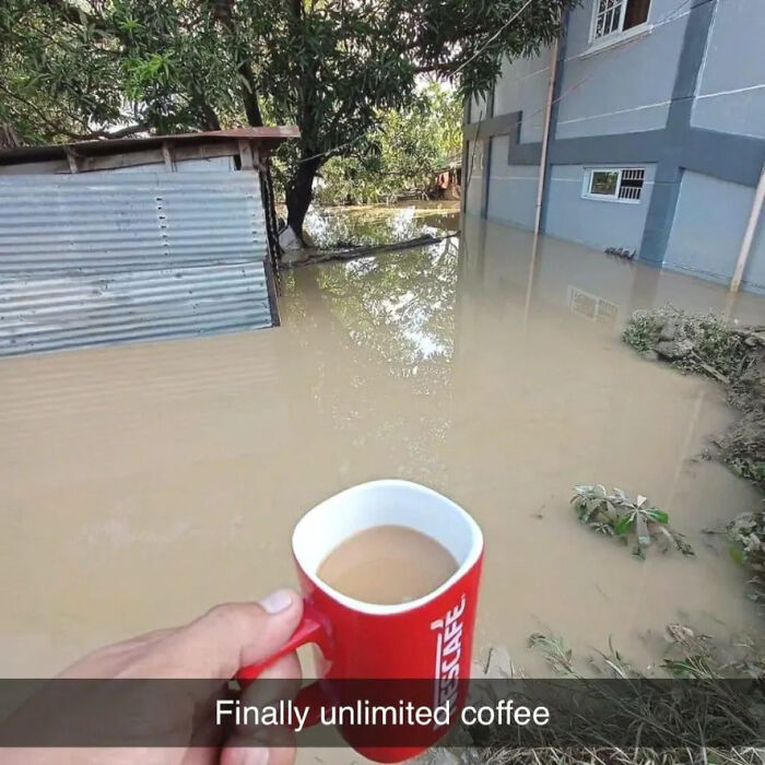 Hand holding a red coffee mug with flooded water surrounding a house and trees, illustrating forbidden foods risks.