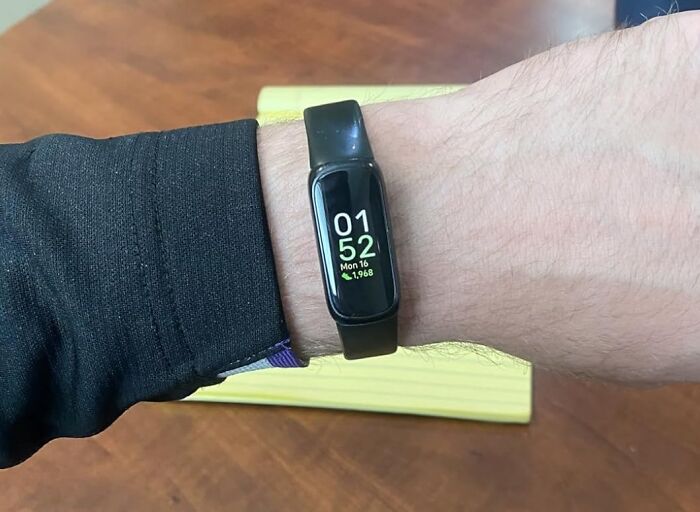 Black fitness tracker on wrist showing time and steps, highlighting popular Black Friday tech deals for nerds.