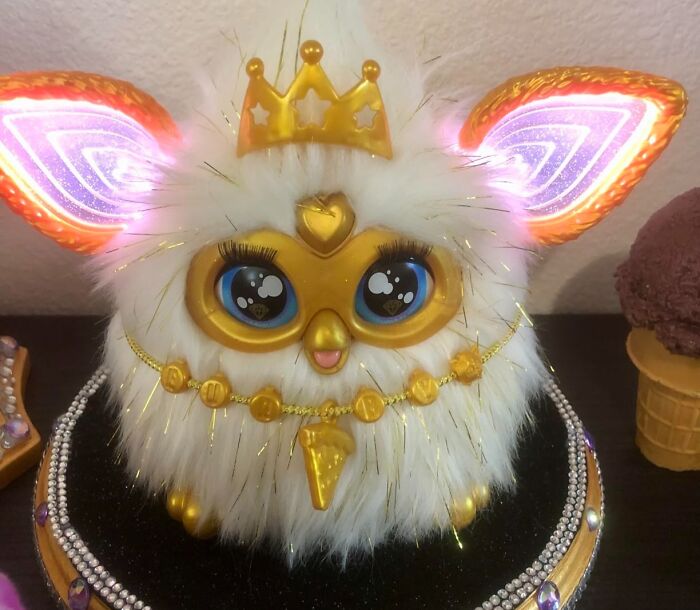 Fluffy white kids toy with glowing ears and golden crown, decorated with shiny beads for Black Friday kids toys deals.
