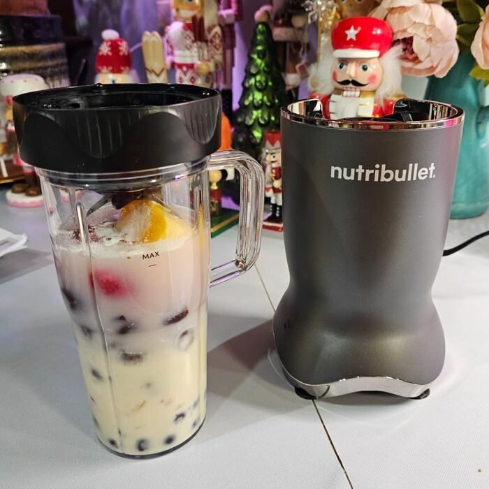 Nutribullet blender with a fruit smoothie container in a festive setting, featuring Alix Earle’s Amazon deals.